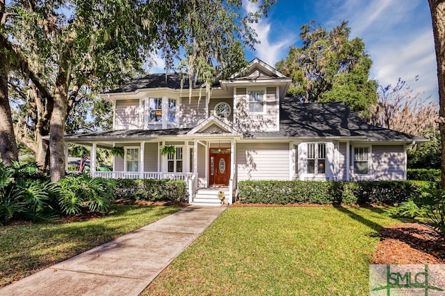 view of front of property with a porch and a front lawn