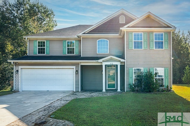 view of front of house with a front yard and a garage