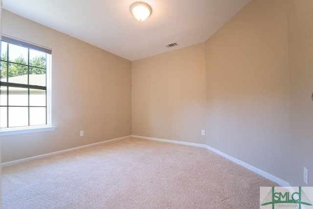 carpeted empty room with visible vents and baseboards