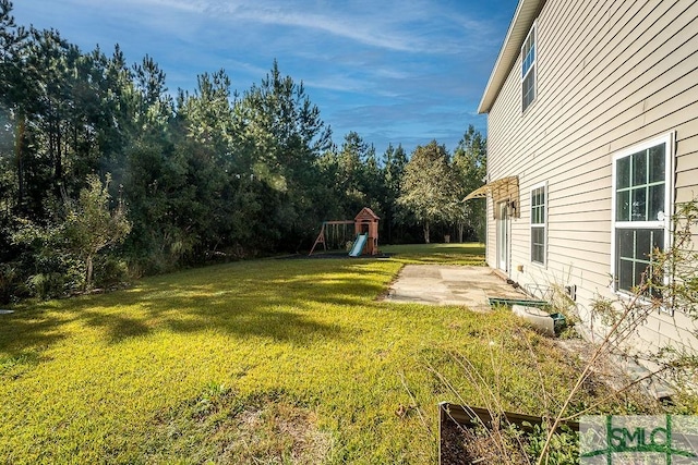 view of yard with a playground and a patio area