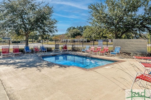 view of pool with a patio area, fence, and a pool