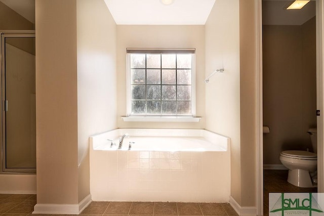 full bathroom with toilet, a garden tub, tile patterned flooring, and a stall shower