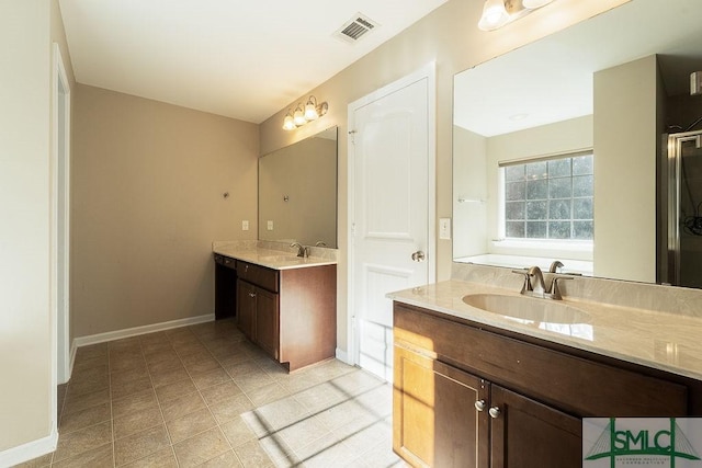 full bathroom featuring two vanities, a sink, visible vents, and baseboards