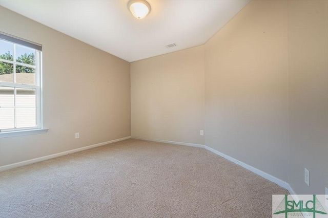 unfurnished room with light carpet, plenty of natural light, visible vents, and baseboards