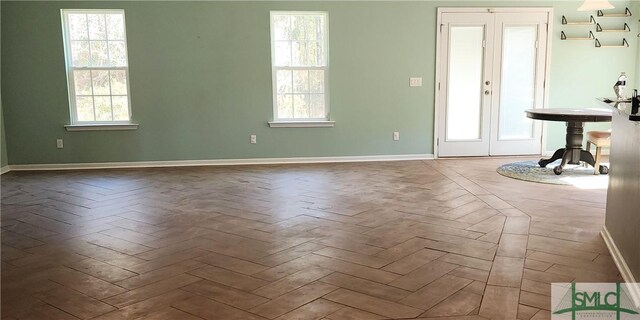 interior space featuring french doors and baseboards