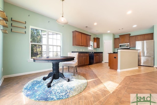 kitchen with brown cabinets, dark countertops, recessed lighting, appliances with stainless steel finishes, and baseboards