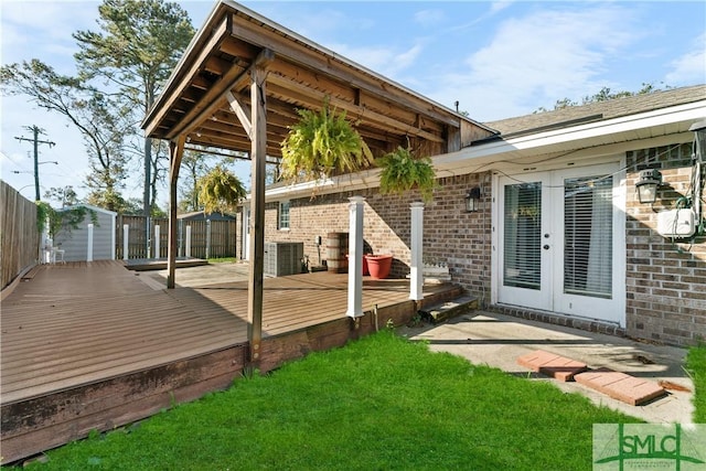 wooden terrace featuring central AC unit, french doors, and fence