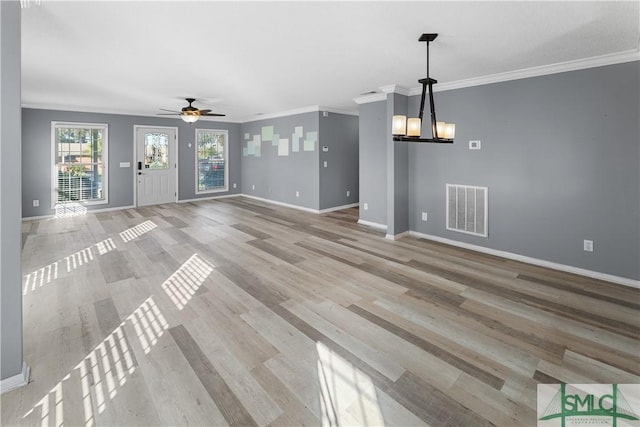 unfurnished living room with light wood-style flooring, baseboards, visible vents, and ornamental molding