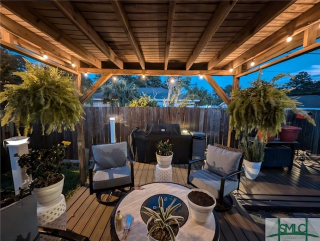 deck featuring a grill and a fenced backyard