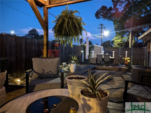 view of patio featuring outdoor dining area, cooling unit, an outdoor structure, and a fenced backyard