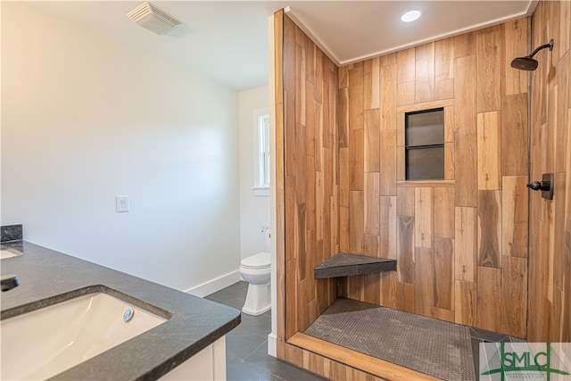 bathroom featuring vanity, toilet, a shower, and tile patterned flooring