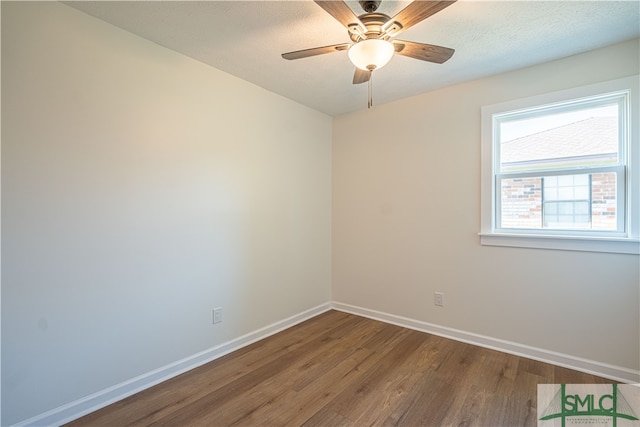 empty room with ceiling fan, hardwood / wood-style flooring, and a textured ceiling