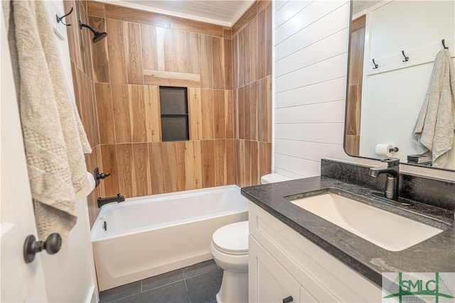 full bathroom with tiled shower / bath, vanity, toilet, and wood walls