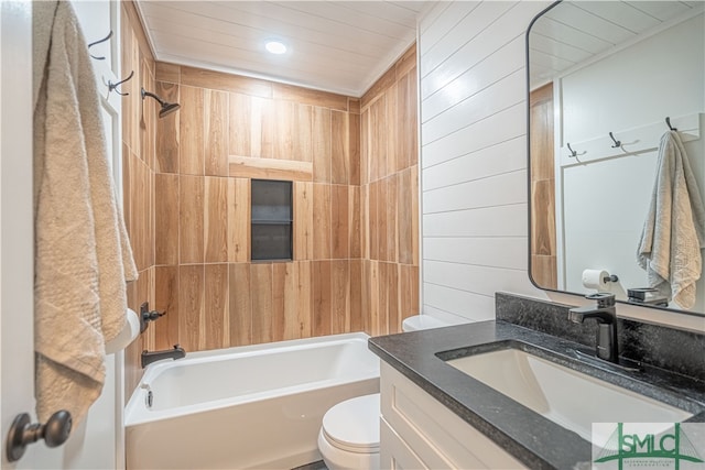 full bathroom featuring toilet, wood walls, tiled shower / bath combo, and vanity