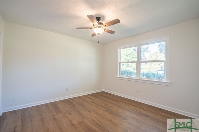 unfurnished room with a textured ceiling, wood-type flooring, and ceiling fan