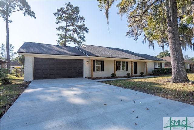 ranch-style home featuring a front lawn and a garage