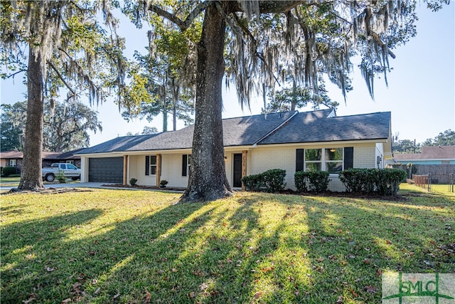 ranch-style home featuring a front lawn and a garage