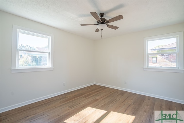 unfurnished room featuring light hardwood / wood-style floors, a textured ceiling, and ceiling fan