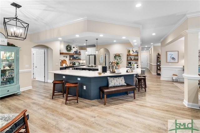 2203 River Oaks Dr, Richmond Hill, GA 31324 - kitchen with light countertops, open shelves, crown molding, and arched walkways