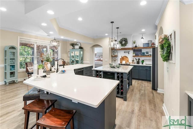 2203 River Oaks Dr, Richmond Hill, GA 31324 - kitchen with light countertops, open shelves, a large island with sink, and a sink