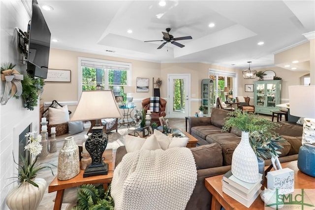 2203 River Oaks Dr, Richmond Hill, GA 31324 - living room with recessed lighting, a tray ceiling, ceiling fan, and a healthy amount of sunlight