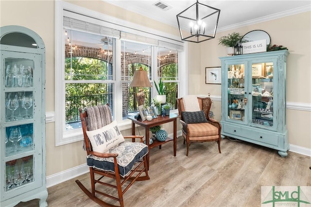 2203 River Oaks Dr, Richmond Hill, GA 31324 - sitting room featuring a chandelier, crown molding, visible vents, baseboards, and wood finished floors