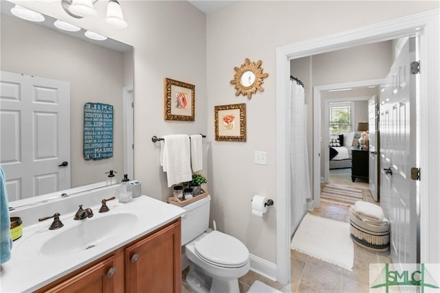 2203 River Oaks Dr, Richmond Hill, GA 31324 - bathroom with toilet, tile patterned floors, vanity, and baseboards