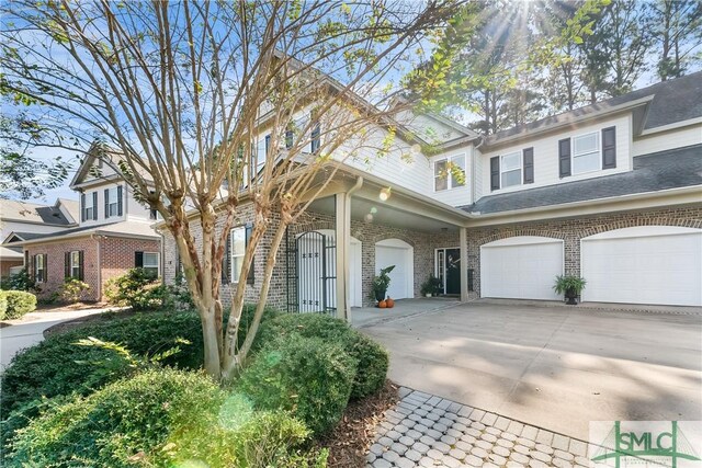 2203 River Oaks Dr, Richmond Hill, GA 31324 - traditional-style home with concrete driveway, brick siding, and an attached garage