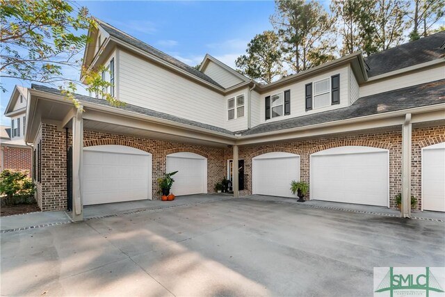 2203 River Oaks Dr, Richmond Hill, GA 31324 - view of front of property featuring brick siding, driveway, and an attached garage