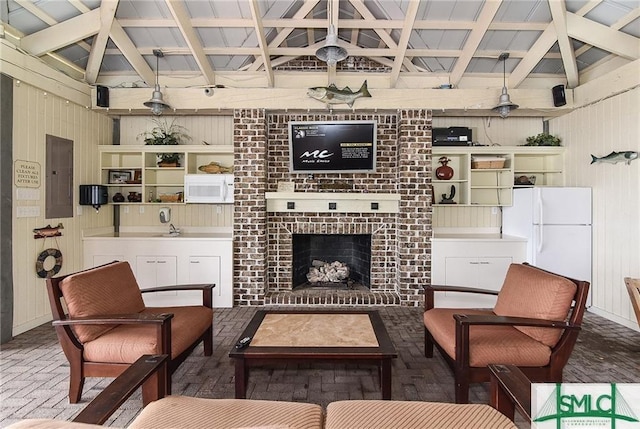 2203 River Oaks Dr, Richmond Hill, GA 31324 - living room with a fireplace, wooden walls, and electric panel