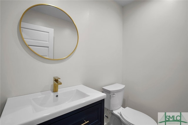 bathroom featuring toilet and vanity