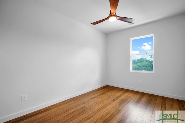 spare room with hardwood / wood-style flooring and ceiling fan