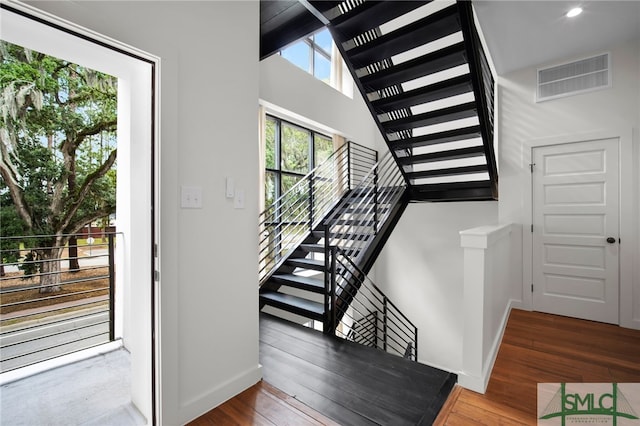 stairway featuring wood-type flooring