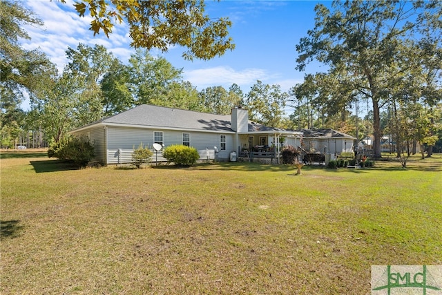 back of house with a lawn