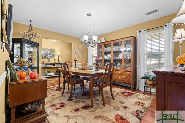 dining room featuring a chandelier and wood-type flooring