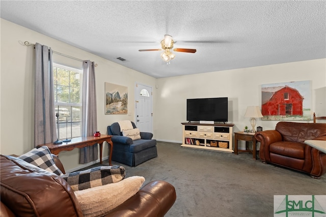 living room featuring carpet flooring, a textured ceiling, and ceiling fan