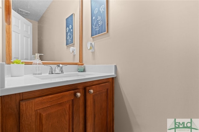 bathroom featuring vanity and a textured ceiling