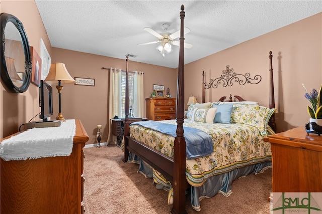 bedroom with a textured ceiling, light colored carpet, and ceiling fan