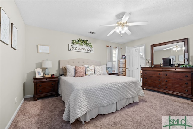 bedroom with a textured ceiling, carpet flooring, and ceiling fan