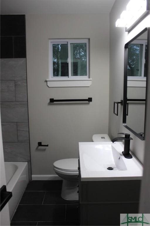 2510 Florida Ave, Savannah, GA 31404 - full bath featuring toilet, vanity, tile patterned floors, baseboards, and bathing tub / shower combination