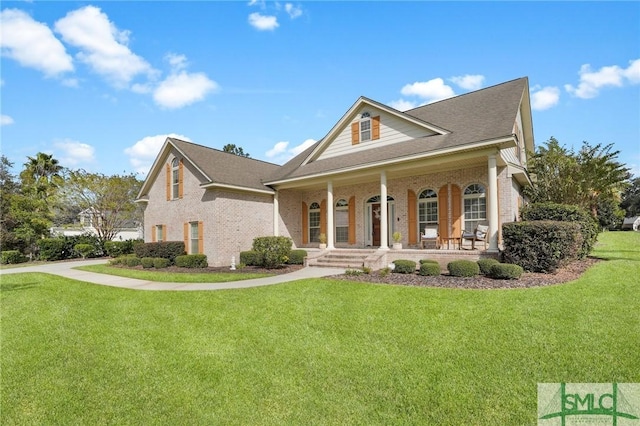 view of front of property with a porch and a front lawn