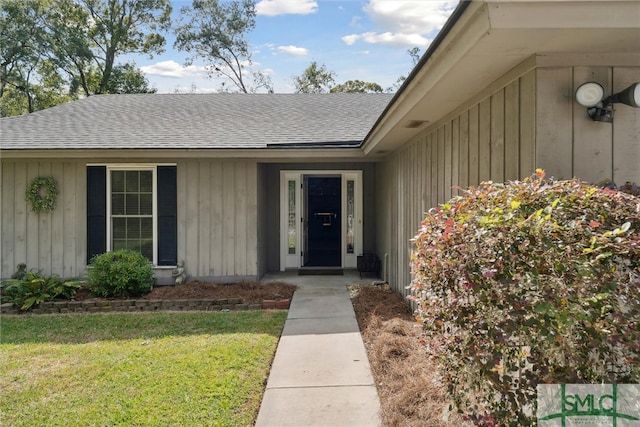 doorway to property with a lawn