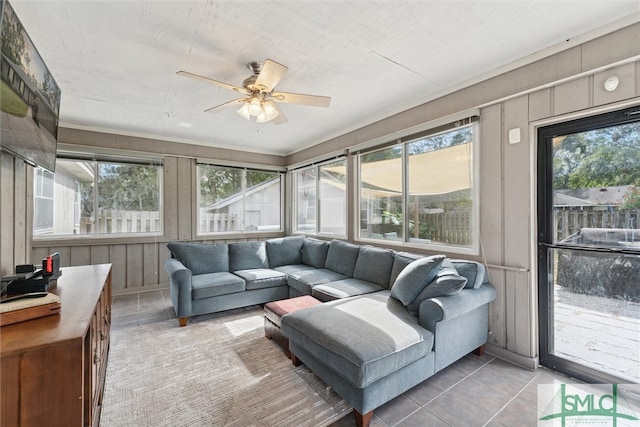 sunroom / solarium featuring ceiling fan