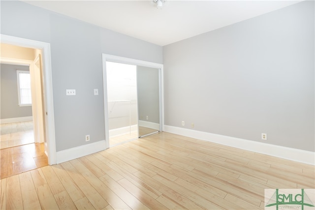 unfurnished bedroom featuring a closet and light hardwood / wood-style flooring