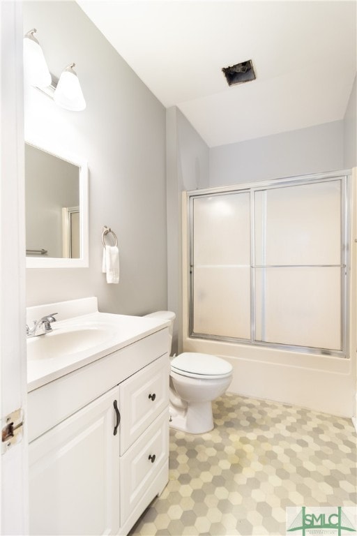 full bathroom with vanity, toilet, and combined bath / shower with glass door