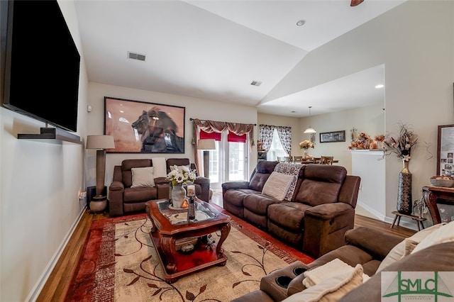 living room with lofted ceiling and hardwood / wood-style floors