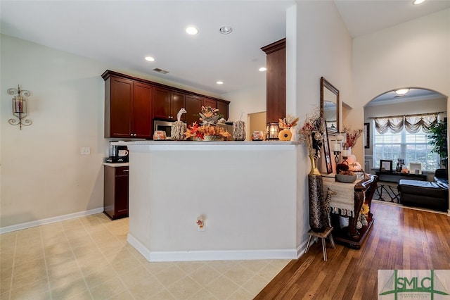 kitchen with light hardwood / wood-style flooring and kitchen peninsula