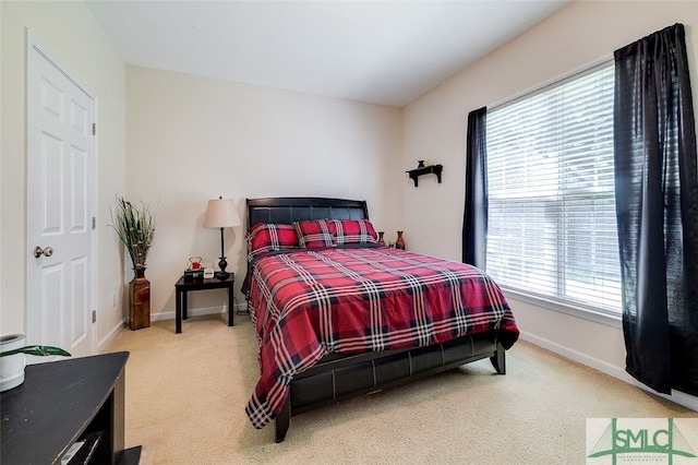 bedroom featuring carpet flooring and multiple windows