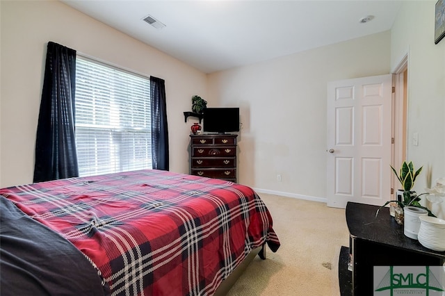 bedroom with light colored carpet