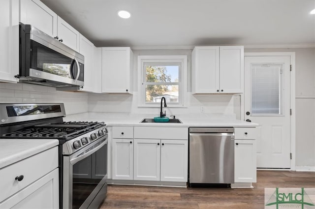 kitchen featuring sink, white cabinets, and appliances with stainless steel finishes